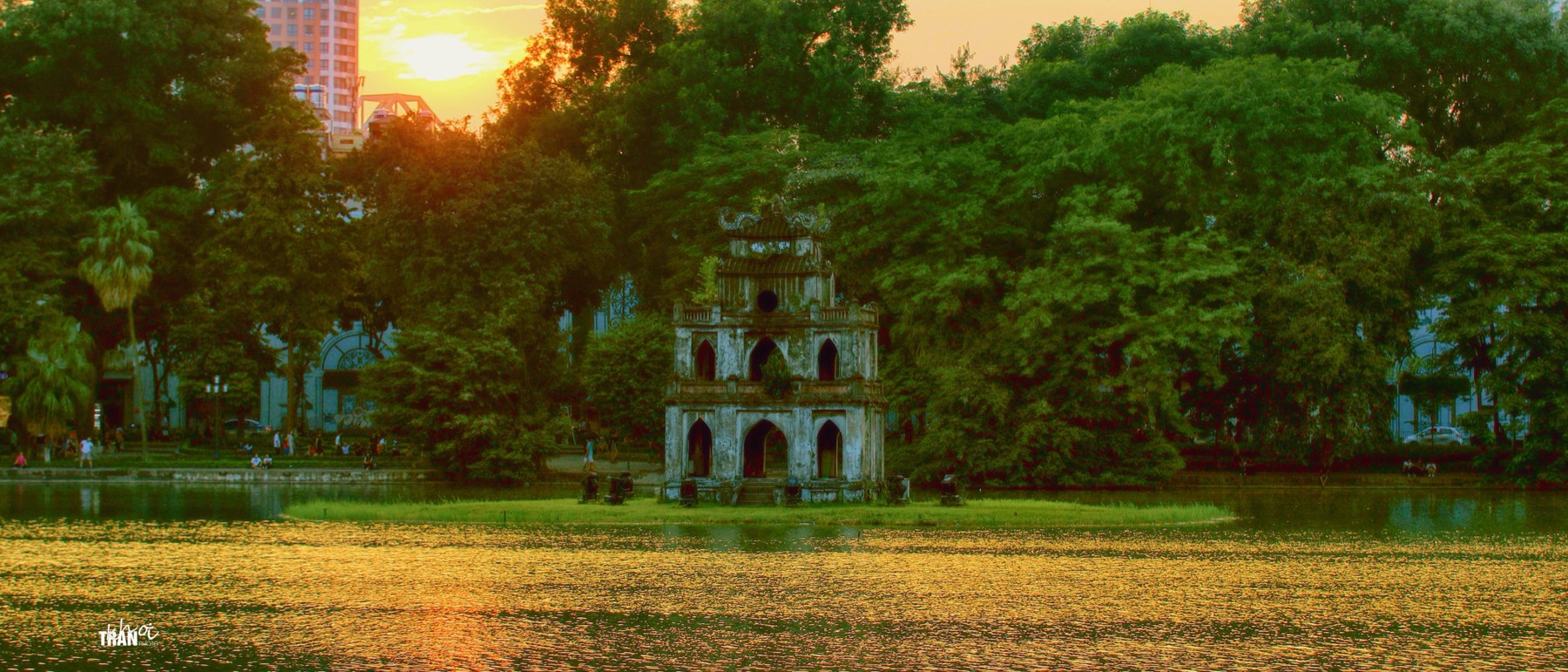 The crimson Turtle Tower rising from the still water of Hoàn Kiếm Lake in central Hà Nội